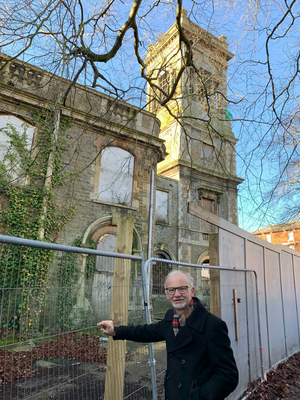 Councillor Stan Pajak standing next to the Locarno building