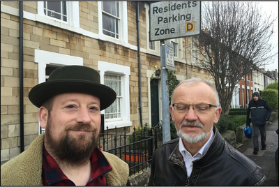 Councillors Toby Robson and Stan Pajak standing next to a Residents Parking Sign in Swindon